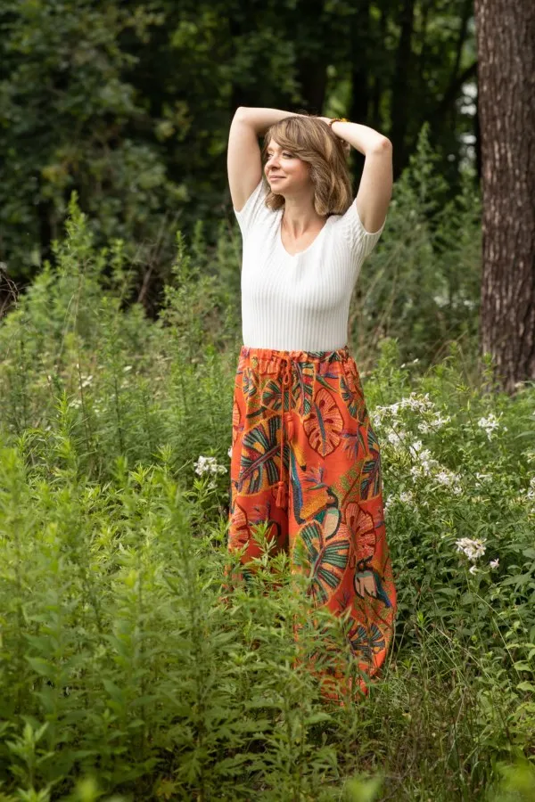 Yael Shy stretching joyfully in a summer garden