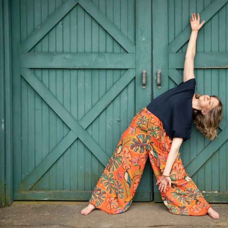 Yael Shy stretching against a green barn door